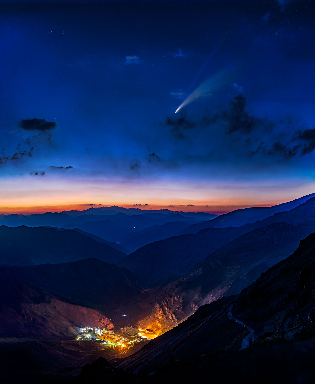 Comet C/2020 F3 (NEOWISE) atop second-highest peak in Iran, mount Alam in the horizon. This picture is a vertical panorama mosaic from valley to the sky taken by Tokina opera 50mm F1.4 FF lens on D610 body.